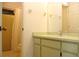 Bright bathroom featuring a shower stall with yellow tiles and a simple vanity with a clean mirror at 6689 Gasparilla Pines Blvd, Englewood, FL 34224