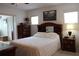 Comfortable bedroom with a plush white patterned bedspread and a view of a chest of drawers at 6689 Gasparilla Pines Blvd, Englewood, FL 34224