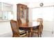 Traditional dining room with wood table, china cabinet, and window at 6689 Gasparilla Pines Blvd, Englewood, FL 34224