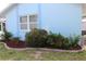 Charming home exterior featuring a well-maintained garden and a bright blue facade at 6689 Gasparilla Pines Blvd, Englewood, FL 34224