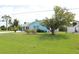 Charming home featuring a well-manicured front yard and mature trees at 6689 Gasparilla Pines Blvd, Englewood, FL 34224
