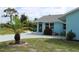 Inviting home exterior boasting a tropical palm tree, garden, and concrete drive at 6689 Gasparilla Pines Blvd, Englewood, FL 34224