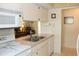 Efficient kitchen with white appliances, plenty of cabinet space, and an adjacent living area at 6689 Gasparilla Pines Blvd, Englewood, FL 34224