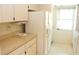 Bright kitchen with white cabinets and appliances, and a window overlooking the outdoors at 6689 Gasparilla Pines Blvd, Englewood, FL 34224