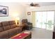 Relaxing living room with comfortable seating and sliding glass doors to the lanai at 6689 Gasparilla Pines Blvd, Englewood, FL 34224