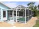 The image shows the property's pool and patio at 6689 Gasparilla Pines Blvd, Englewood, FL 34224