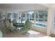 Charming sunroom with expansive windows, tiled floors, and stylish decor at 6689 Gasparilla Pines Blvd, Englewood, FL 34224