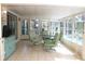 Spacious sunroom with pool view, tile floors, and comfortable seating at 6689 Gasparilla Pines Blvd, Englewood, FL 34224