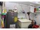 The image shows a utility sink, a hot water heater, and storage shelves at 6689 Gasparilla Pines Blvd, Englewood, FL 34224