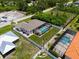 Home surrounded by fence, manicured landscaping, and a screened-in pool enclosure at 8081 Dimstead St, Port Charlotte, FL 33981
