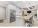 Kitchen with an island, stainless steel appliances, ample counter space, and seating, open to the living room at 8081 Dimstead St, Port Charlotte, FL 33981