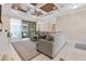 Living room showcases a comfortable seating area, ceiling fan, and natural light with access to the outdoor swimming pool at 8081 Dimstead St, Port Charlotte, FL 33981