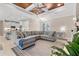 The living room is open to the kitchen, features a large sectional sofa and decorative ceiling at 8081 Dimstead St, Port Charlotte, FL 33981