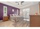 Spacious main bedroom features tray ceiling, purple accent wall, and access to the pool area at 8081 Dimstead St, Port Charlotte, FL 33981