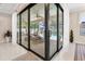 Large sliding glass doors lead to a screened in patio with a clear view of the pool at 8081 Dimstead St, Port Charlotte, FL 33981