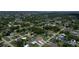 Aerial view of a neighborhood full of homes with mature trees and a body of water in the background at 871 Columbia St, Port Charlotte, FL 33948