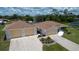 Aerial view of a single-story home with a two car garage, attached two car garage, and an American flag out front at 871 Columbia St, Port Charlotte, FL 33948
