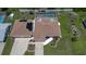 Aerial view of the roof of a single-story home with a screen-enclosed pool and two car garage at 871 Columbia St, Port Charlotte, FL 33948