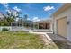 Enjoy this spacious backyard featuring a screened-in pool and patio at 871 Columbia St, Port Charlotte, FL 33948