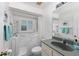 Accessible bathroom with walk-in tub, neutral color scheme, and modern fixtures at 871 Columbia St, Port Charlotte, FL 33948