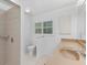 Bright bathroom featuring a walk-in shower and vanity with sink at 871 Columbia St, Port Charlotte, FL 33948