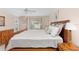 Bedroom showcasing a comfortable bed, sliding glass doors and natural light at 871 Columbia St, Port Charlotte, FL 33948