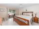 Bright bedroom featuring a wooden bed, tile floors, and sliding glass doors at 871 Columbia St, Port Charlotte, FL 33948