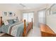 Cozy bedroom with a wooden four-poster bed, ceiling fan and natural light at 871 Columbia St, Port Charlotte, FL 33948