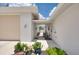 Exterior view of the home with a garage and side yard at 871 Columbia St, Port Charlotte, FL 33948