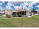 Well maintained home with a manicured lawn, screened in porch, and landscaping at 871 Columbia St, Port Charlotte, FL 33948