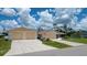 Charming single-story home with a two car garage, attached two car garage, and a well-manicured front yard at 871 Columbia St, Port Charlotte, FL 33948