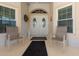 Inviting front porch with double doors, seating, and decorative accents at 871 Columbia St, Port Charlotte, FL 33948