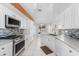 Bright kitchen boasts white cabinets, stainless steel appliances, and granite countertops at 871 Columbia St, Port Charlotte, FL 33948