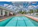 Sparkling screened-in pool is perfect for enjoying the outdoors with poolside seating and relaxing views at 871 Columbia St, Port Charlotte, FL 33948