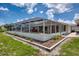 Screened-in pool, patio, and landscaped backyard create the ideal outdoor living space at 871 Columbia St, Port Charlotte, FL 33948
