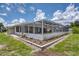 Outdoor oasis featuring a screened-in pool and lush landscaping at 871 Columbia St, Port Charlotte, FL 33948