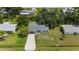 An aerial view of a well-maintained home with a long driveway and mature trees at 879 E Seminole Dr, Venice, FL 34293