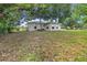 Green backyard featuring mature trees that provide shade and privacy at 879 E Seminole Dr, Venice, FL 34293