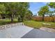 A fenced-in backyard with trees and a concrete patio, ready for outdoor enjoyment at 879 E Seminole Dr, Venice, FL 34293