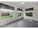 Sunroom features tile flooring and three large windows overlooking the backyard at 879 E Seminole Dr, Venice, FL 34293