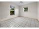 Bedroom with tile floors and two windows providing natural light at 879 E Seminole Dr, Venice, FL 34293