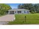 Charming single-story home featuring a well-maintained lawn and cozy curb appeal with an attached carport at 879 E Seminole Dr, Venice, FL 34293