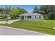 Charming single-story home featuring a well-maintained lawn and cozy curb appeal with an attached carport at 879 E Seminole Dr, Venice, FL 34293