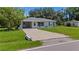 Charming single-story home with a well-maintained lawn, spacious driveway, and inviting entryway at 879 E Seminole Dr, Venice, FL 34293