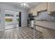 Bright kitchen featuring stainless steel appliances, tile floors, and access to a spacious living area at 879 E Seminole Dr, Venice, FL 34293