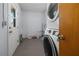 Laundry room features a stackable washer and dryer unit and a door to the outside at 879 E Seminole Dr, Venice, FL 34293