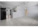 A spacious living room with tile flooring, ceiling fans, and neutral paint, offering a versatile living space at 879 E Seminole Dr, Venice, FL 34293