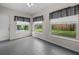 Bright sunroom with tile floor and three large windows offering backyard views at 879 E Seminole Dr, Venice, FL 34293