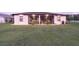 A beautifully landscaped backyard with a screened patio, grill, and lush green grass at 1275 Blue Lake Cir, Punta Gorda, FL 33983
