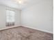 Bright bedroom with neutral walls, carpeting, and a large window at 1275 Blue Lake Cir, Punta Gorda, FL 33983